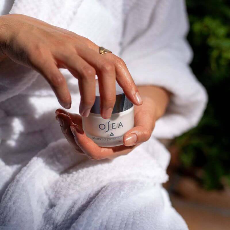 Woman holding organi skincare product